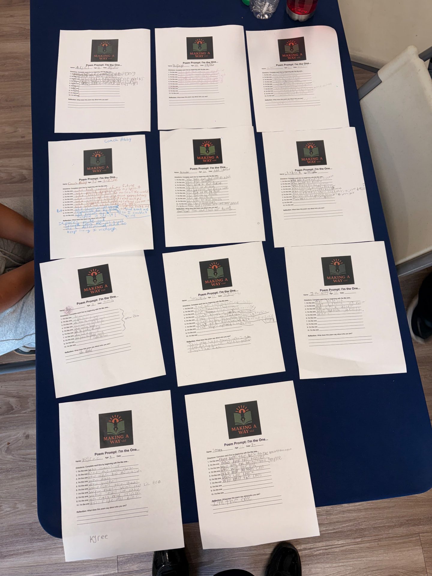 Young poets' finished poem worksheets laid out on a table